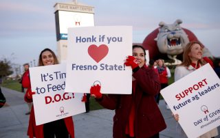 Students hold sign for Day of Giving