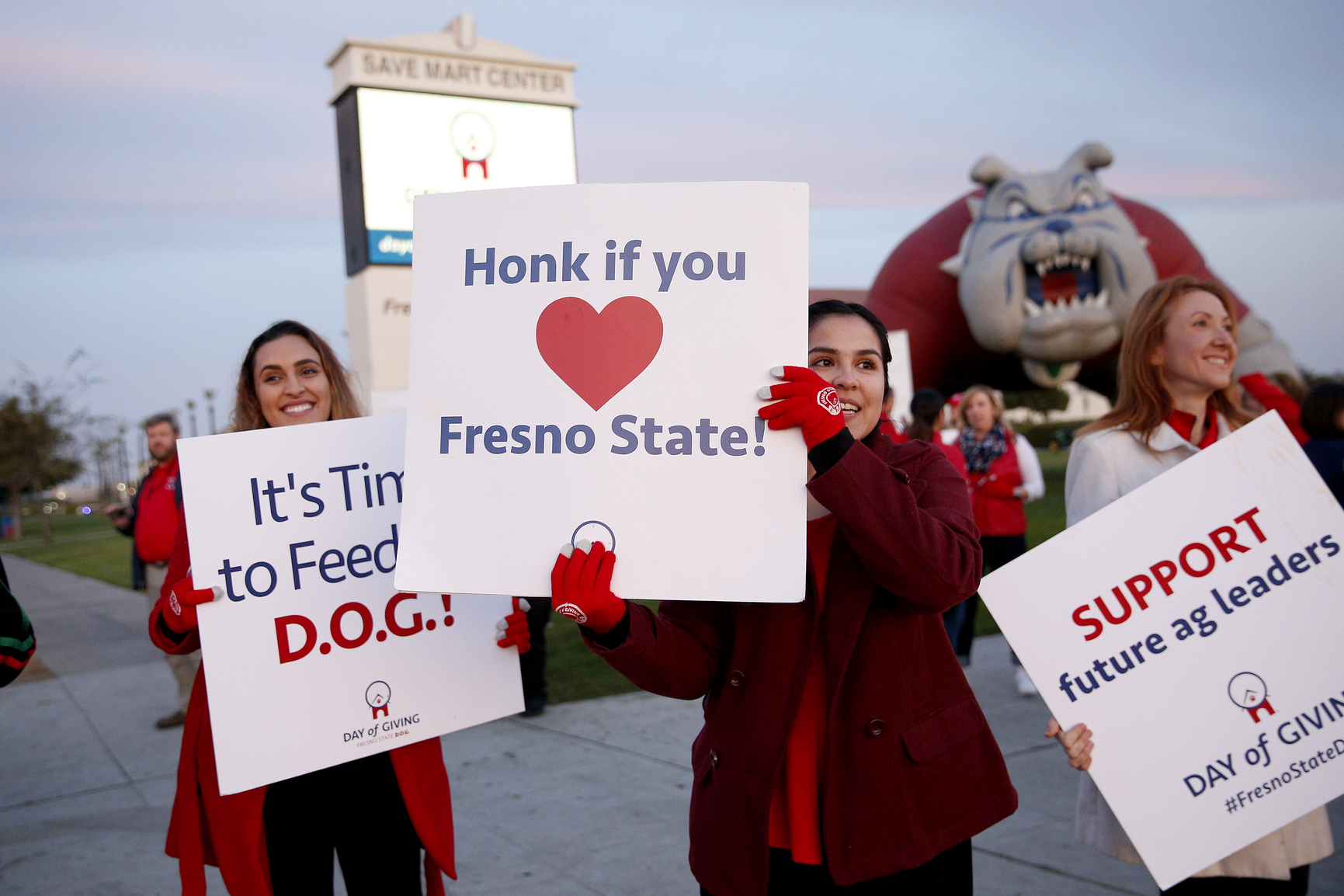 Students hold sign for Day of Giving