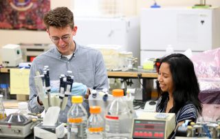 Micah Olivas (left) and Alyssa Rivera (right) in the lab