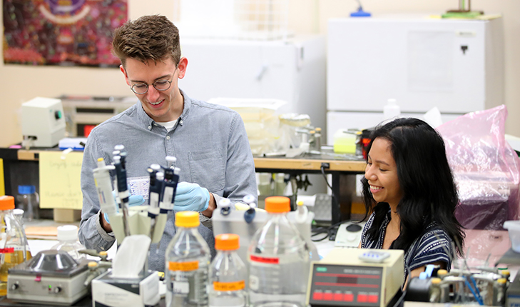 Micah Olivas (left) and Alyssa Rivera (right) in the lab