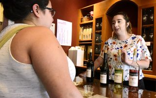 Winery employee guiding a wine taster