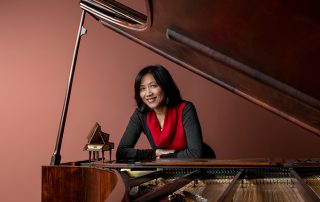 Gwendolyn Mok sitting at a piano