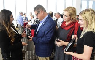 President Castro and Mary Castro reviewing campus wine