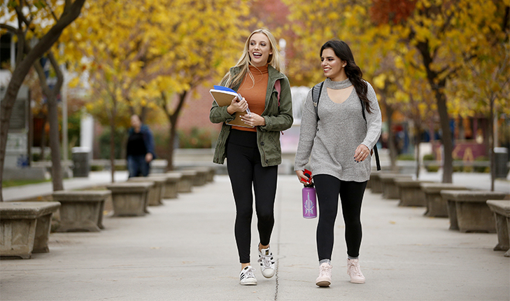 Fresno State students walk through campus on a fall day.