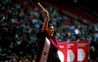 A student celebrates at the 2019 Fresno State commencement ceremony.