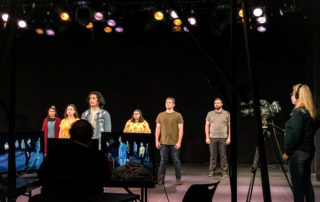 Students perform on stage for virtual University Theatre production.