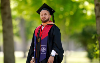 Mustafa Ali in cap and gown