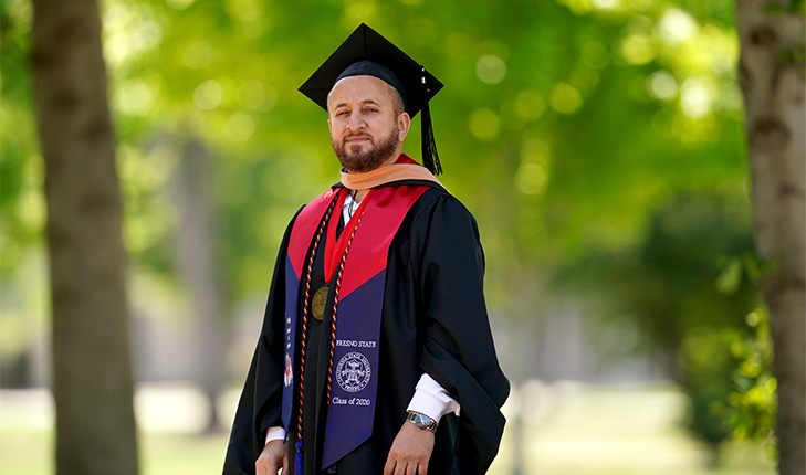 Mustafa Ali in cap and gown