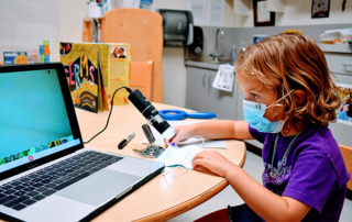 Child working on a laptop.