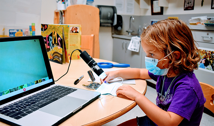 Child working on a laptop.