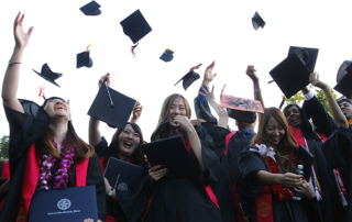 Students throwing graduation caps