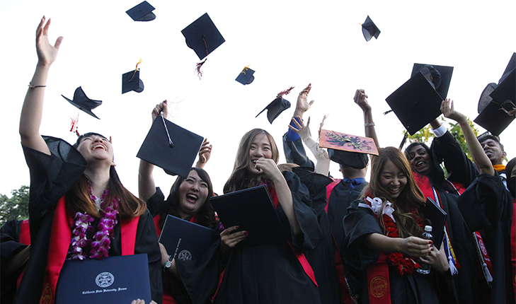 Students throwing graduation caps