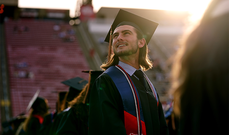 Student looking up during graduation ceremony,\.