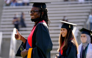 Fresno State students walking at graduation ceremonies.
