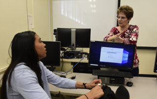 Dr. Annette Levi, ag business, speaks to a student.