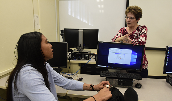 Dr. Annette Levi, ag business, speaks to a student.