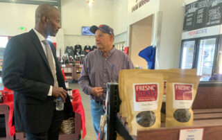 Dr. Rolston St. Hilaire and another man talking in Gibson Farm Market.