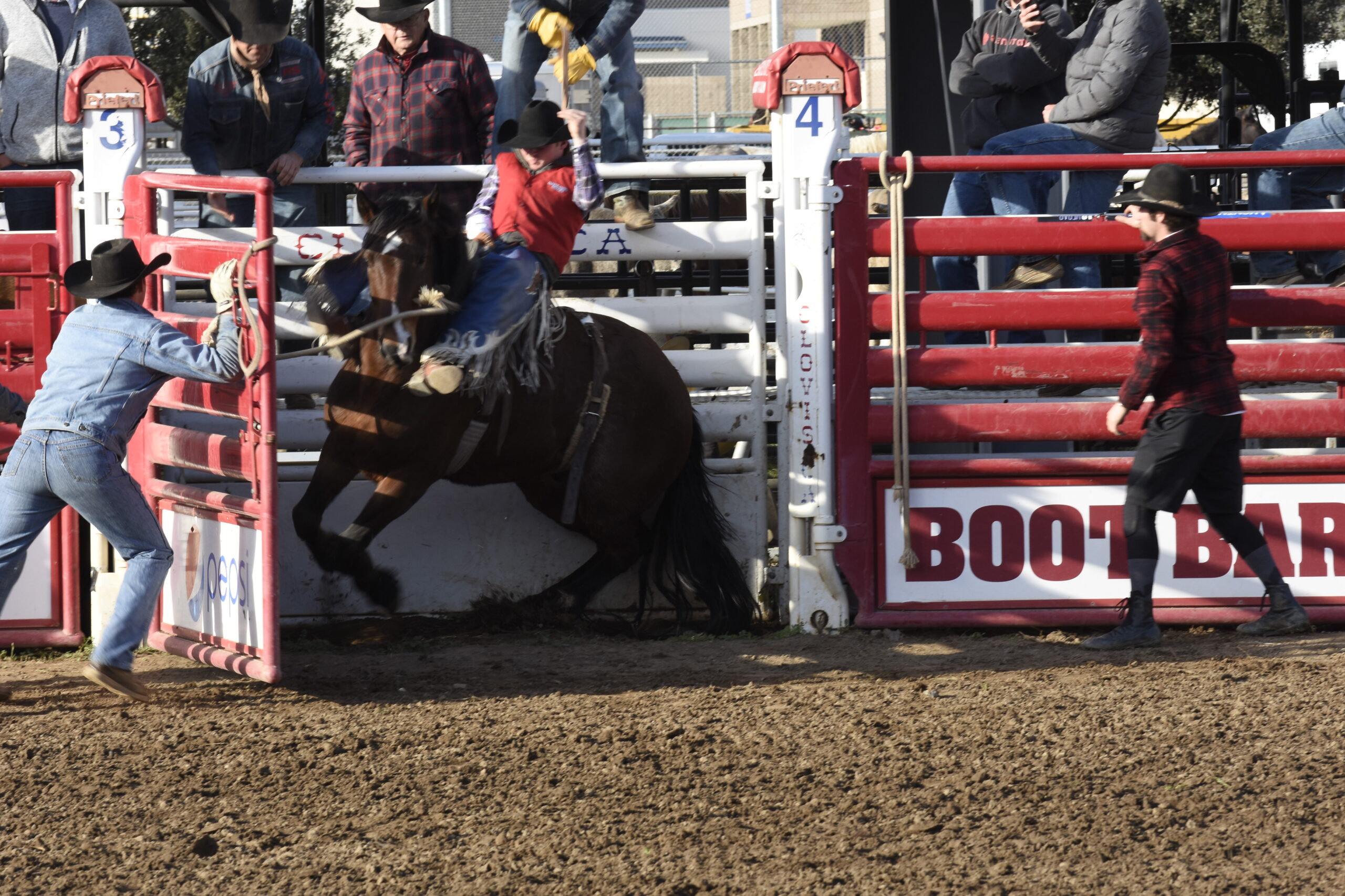 A student riding a horse in the rodeo