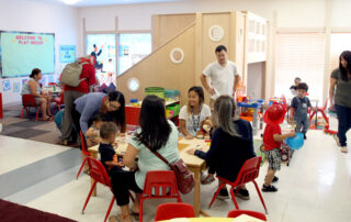 Students around tables in a classroom.