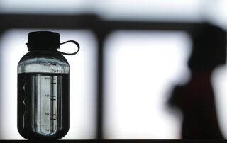 close up shot of water bottle with a blurred background.