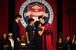 Fresno State President Saúl Jiménez-Sandoval is greeted by wife Dr. Mariana Anagnostopoulos and sons Arion and Leo.