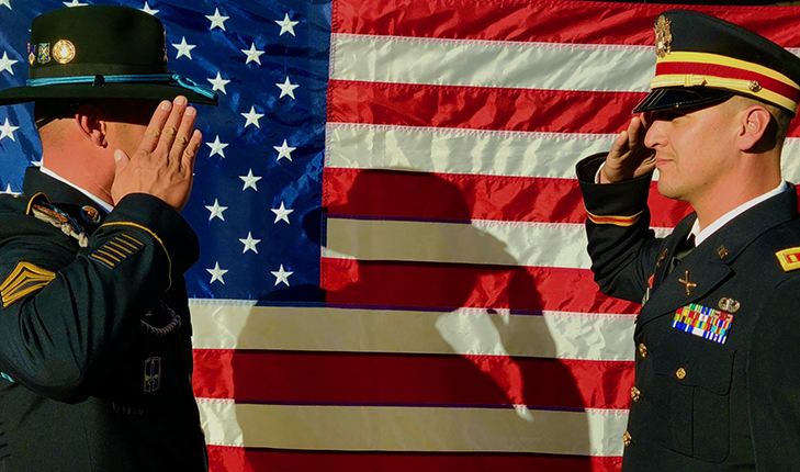 soldiers in front of American flag