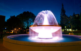 Fresno State water fountain at night.