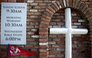 A church sign gives service times ahead of Fresno State's Super Sunday outreach.