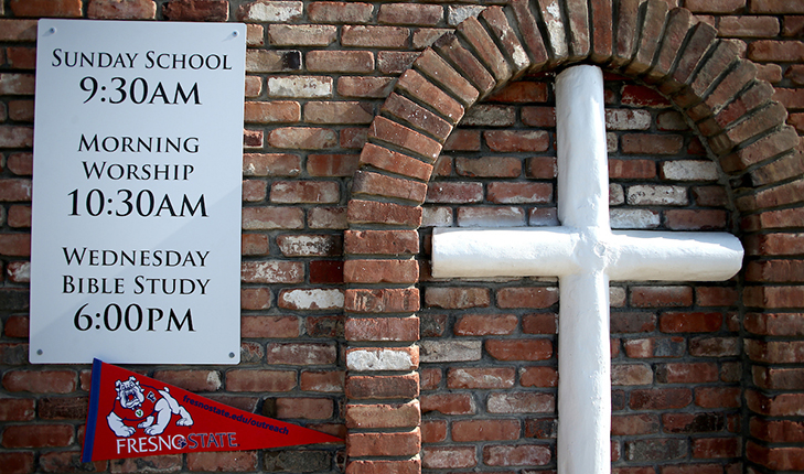 A church sign gives service times ahead of Fresno State's Super Sunday outreach.