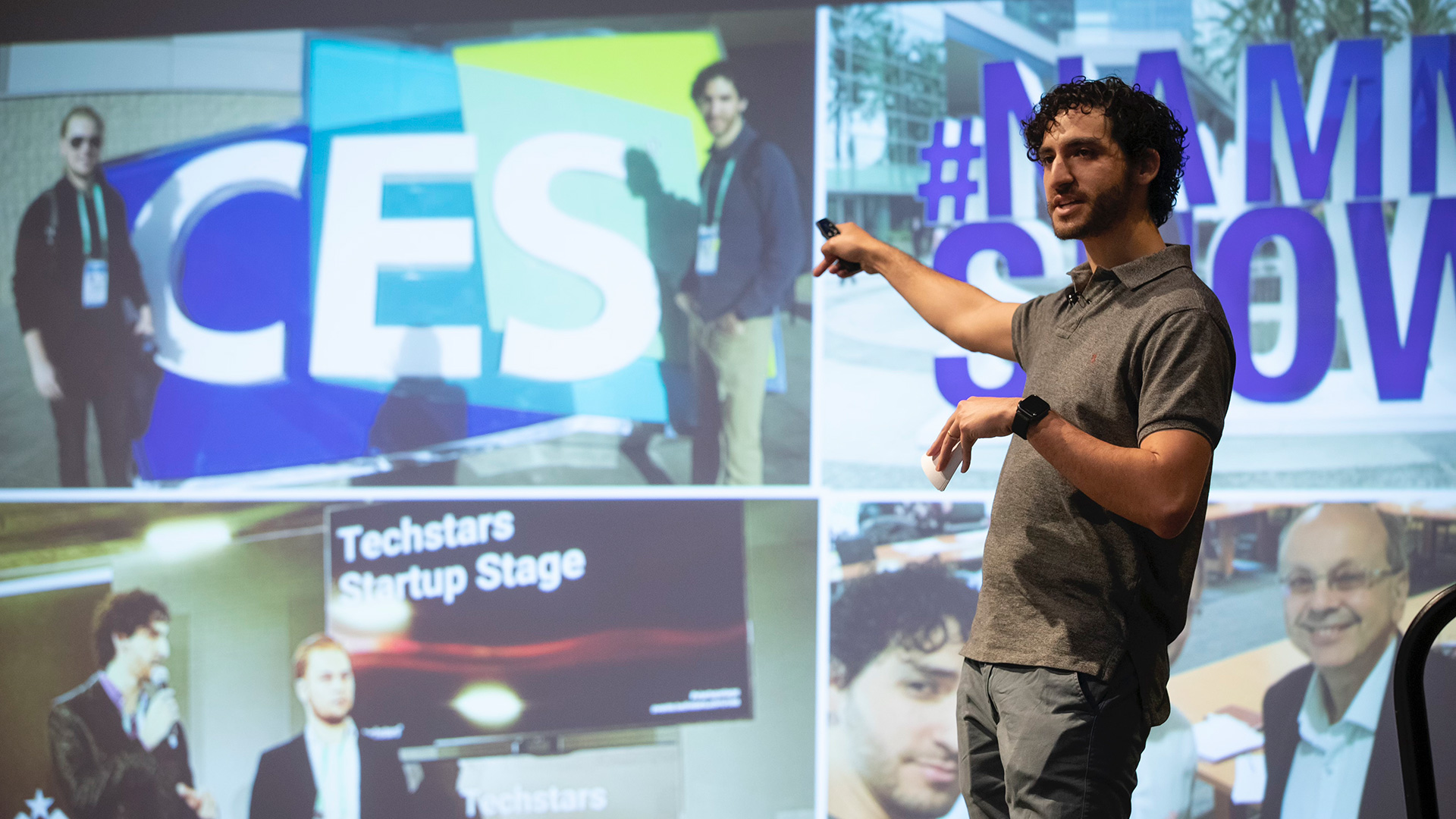 Ethan Castro pointing to a PowerPoint about Techstars Startup Stage.