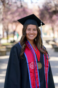 Portrait of Daisy Soto-Hernandez in graduation cap and gown.