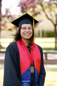 Portrait of Emma Escandon in graduation cap and gown.