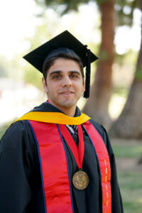 Portrait of Gregory Dzhezyan in graduation cap and gown.