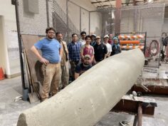 Lyles College of Engineering students posing with their concrete canoe. 