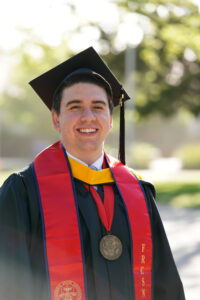 Portrait of Jonathan Moules in graduation cap and gown.