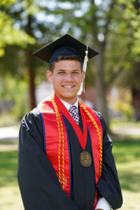 Portrait of Lucca Lorenzi in graduation cap and gown.