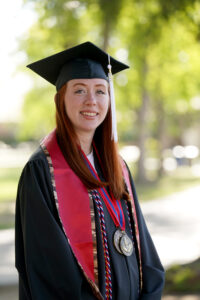 Portrait of Natalie Allison in graduation cap and gown. 