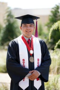 Portrait of Sylas Ramos in graduation cap and gown.