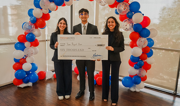 Students holding check