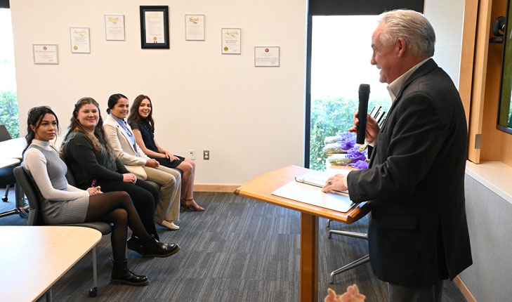 Jim Patterson at podium speaking to students