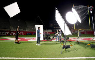 Famous Fresno State alumnus on field at Valley Children's Stadium for commercial TV filming.