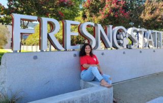 Maria Pacheco in front of Fresno State sign