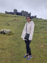 Simranjeet Sekhon stands in front of a castle while studying abroad in Wales. 