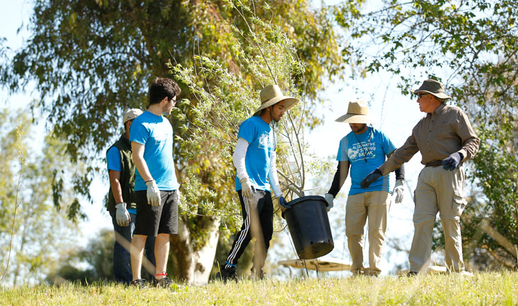 Fresno State students volunteer for environmental projects at Scout Island.