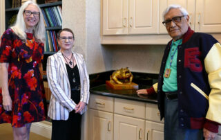 Joseph Guadalupe Garcia, the artist behind the iconic four-paw Bulldog logo, poses with a sculpture he created.