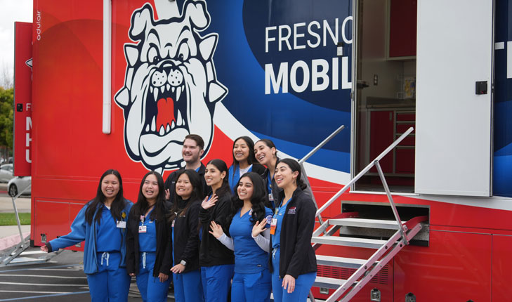 Students stand in front of new mobile health unit.