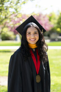 Belen Torres, Kremen School of Education and Human Development, in graduation robes.