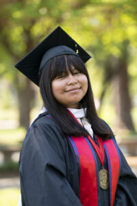 Hermelinda Hernandez Monjaras, College of Arts and Humanities, in graduation robes.