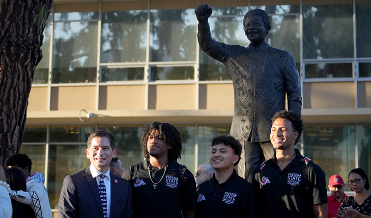 President Saul Jimenez and students in front of Mandela statue