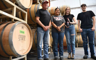 Fresno State winemaker Tom Montgomery (left) with students Malia Mora, Preston Jenkins and Keara McVicker.